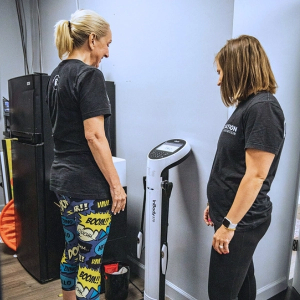 Member preparing for an InBody scan with coach